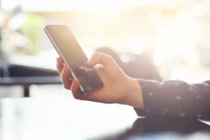 Close Up Or Persons Hand Holding A Phone